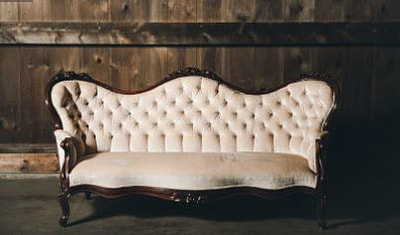 This beautiful white or off white tufted sofa is upholstered in velvet, making it comfortable as well to rent for a wedding or party.